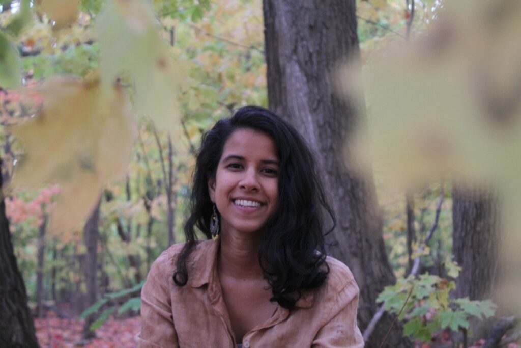 Portrait of Nimra Bandukwala in an autumn forest.