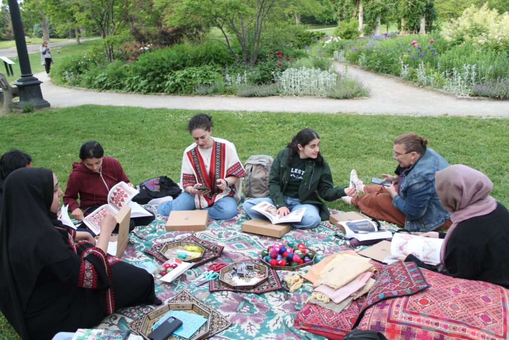 participants gathered at the park embroidering their squares